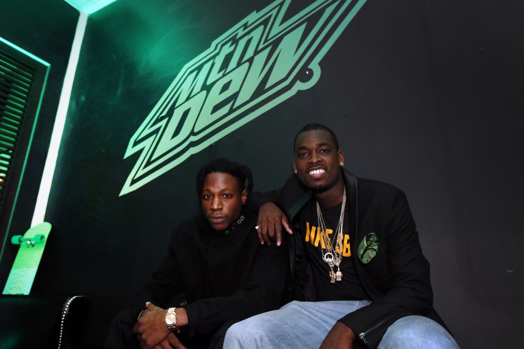 Hip Hop artist Joey Bada$$, left, and pro skateboarder Theotis Beasley have a damn good time, with a touch of class, at an event for MTN DEW BLACK LABEL at Parlor, on Thursday, April 14, 2016 in New York. MTN DEW BLACK LABEL is A DEEPER DARKER DEW that's now available nationwide. (Jason DeCrow/AP Images for MTN DEW BLACK LABEL)